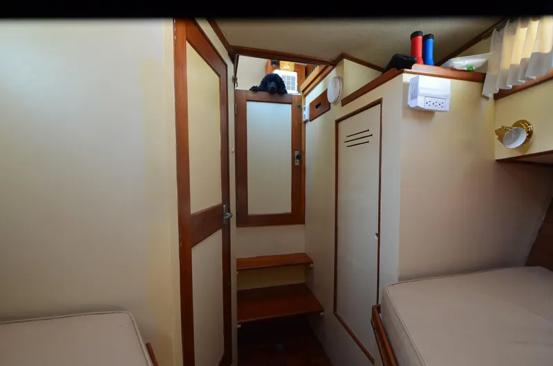 Slide: The Image of Interior of 1977 Grand Banks GB 32 boat cabin with wooden accents and cozy layout. - 13