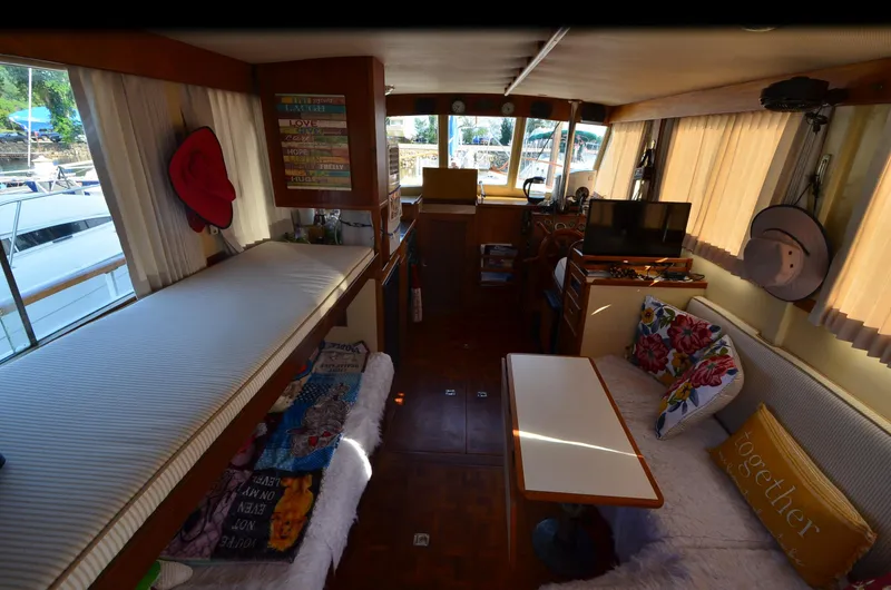 Slide: The Image of Interior of a 1977 Grand Banks GB 32 boat with cozy seating and decor. - 14