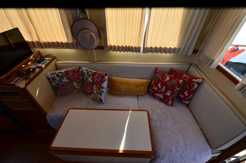 Slide: The Image of Cozy interior of 1977 Grand Banks GB 32 with colorful cushions and table. - 15