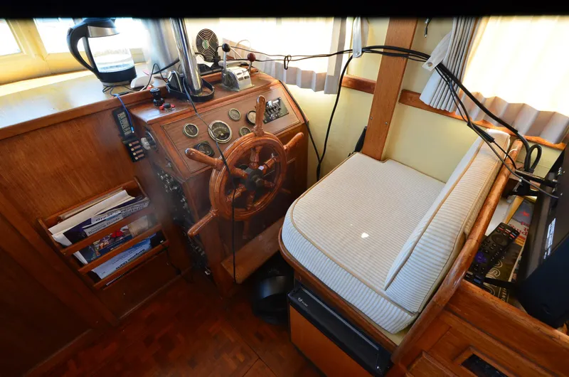 Slide: The Image of 1977 Grand Banks GB 32 helm with wooden wheel and navigation instruments. - 19