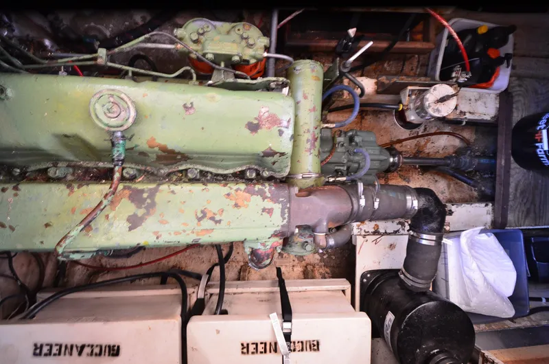 Slide: The Image of Engine room of a 1977 Grand Banks GB 32 boat, showing machinery and components. - 23