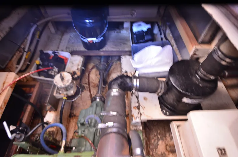 Slide: The Image of Engine room of 1977 Grand Banks GB 32 boat, showing mechanical components and storage. - 24