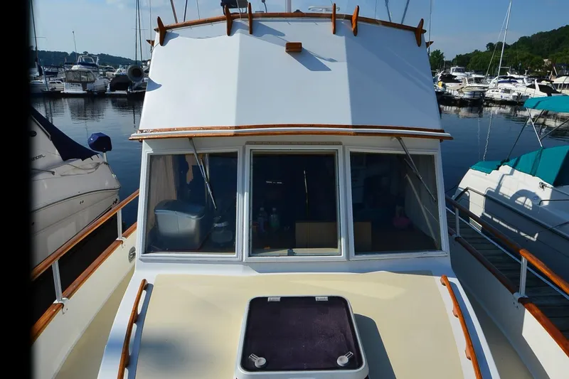 Slide: The Image of 1977 Grand Banks GB 32 yacht docked at a marina, showcasing its classic design. - 31