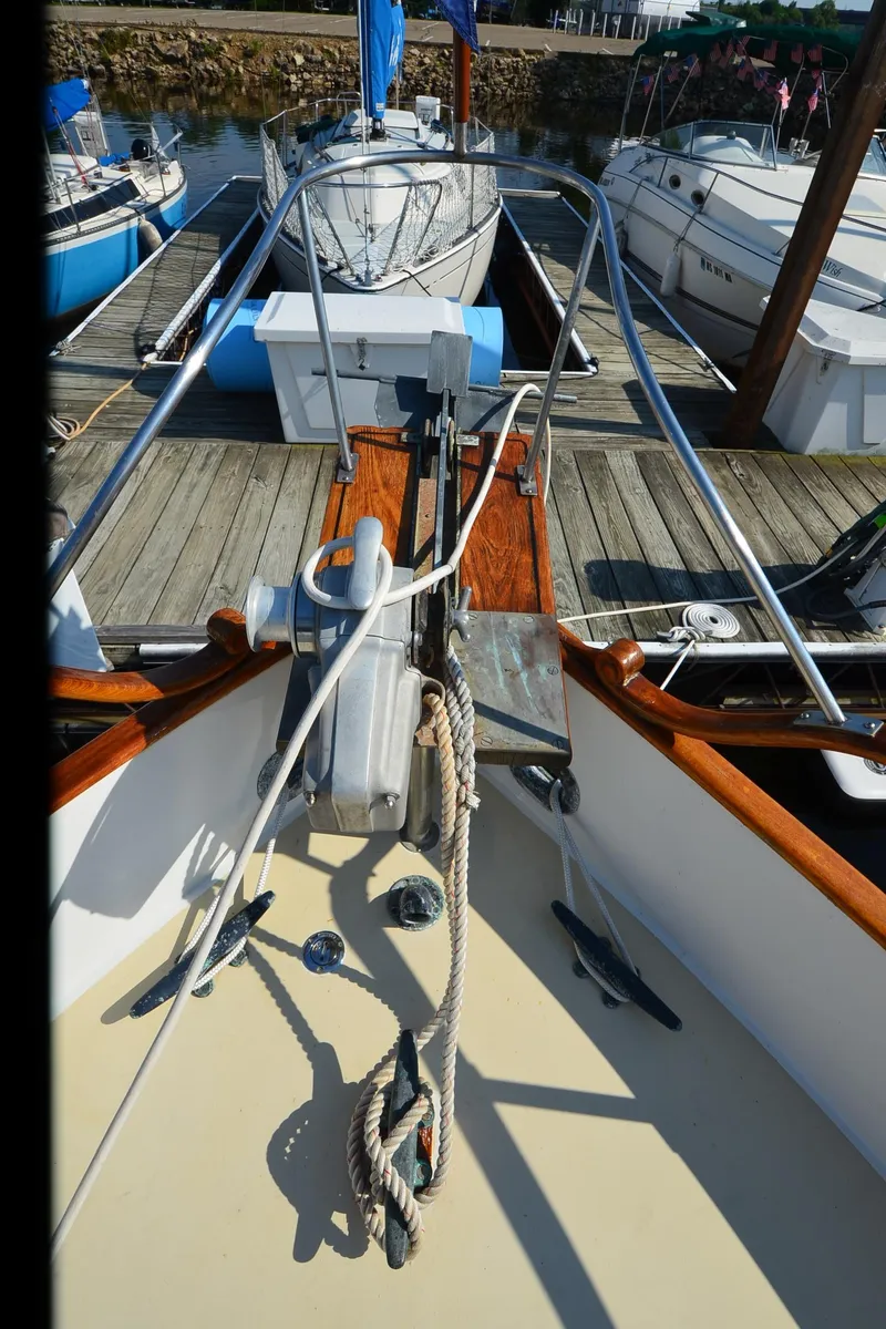 Slide: The Image of 1977 Grand Banks GB 32 yacht bow with ropes and dock view. - 32