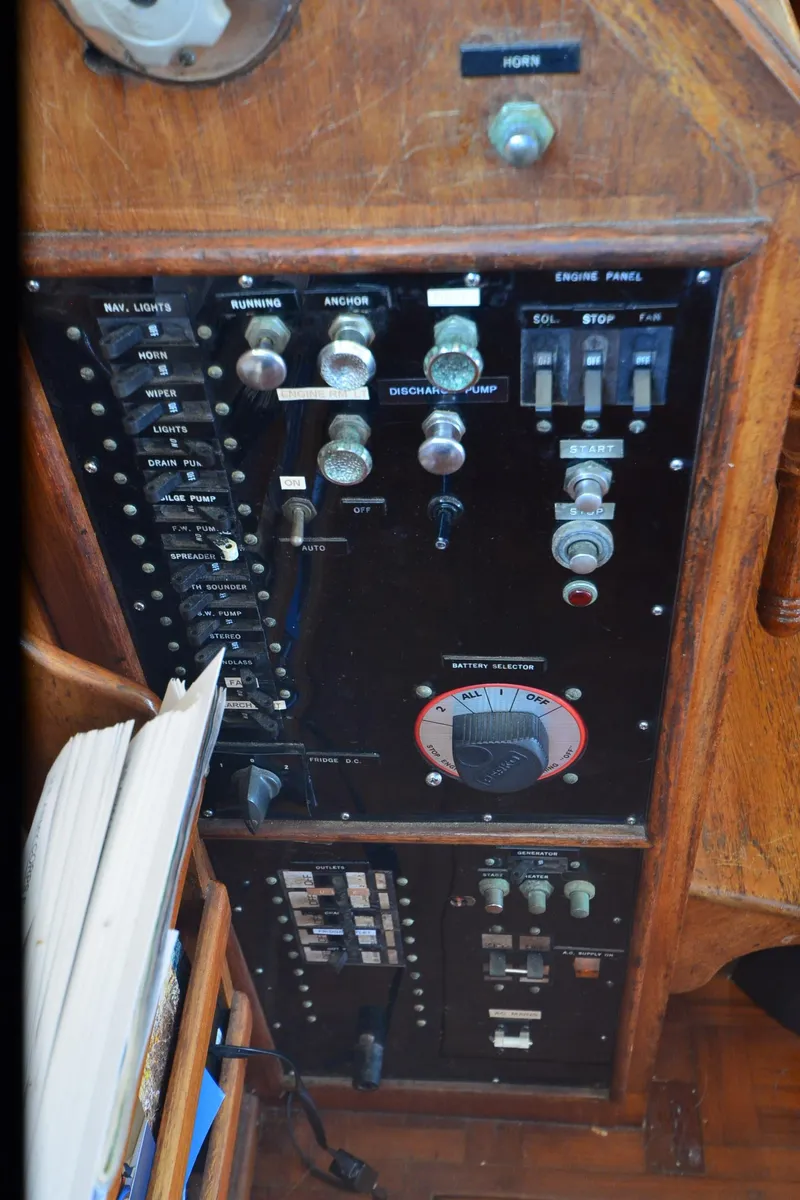 Slide: The Image of Control panel of a 1977 Grand Banks GB 32 boat, featuring various switches and dials. - 37