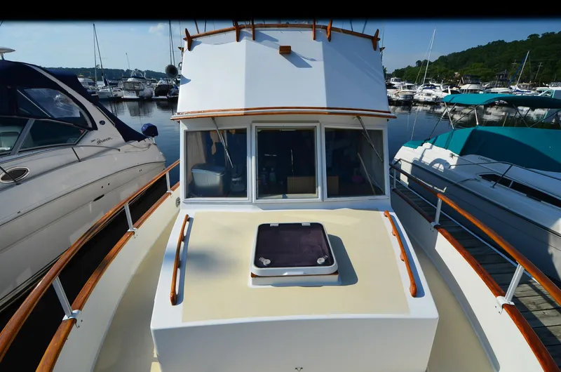 Slide: The Image of 1977 Grand Banks GB 32 yacht docked at marina, surrounded by other boats. - 4