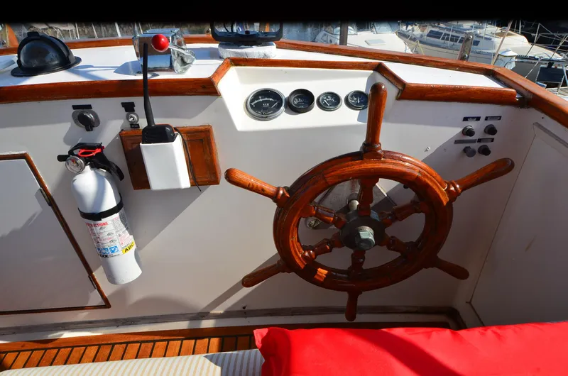 Slide: The Image of 1977 Grand Banks GB 32 helm with wooden wheel and control panel. - 6