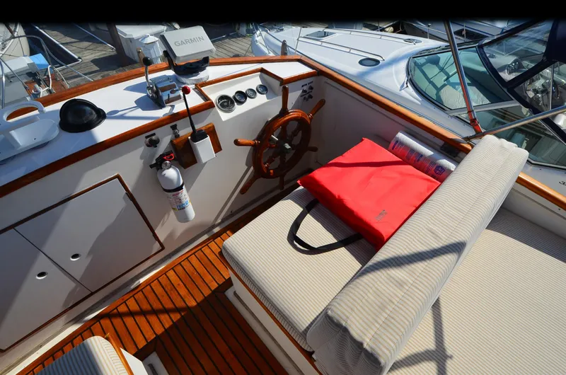 Slide: The Image of 1977 Grand Banks GB 32 boat cockpit with wooden steering wheel and navigation equipment. - 7