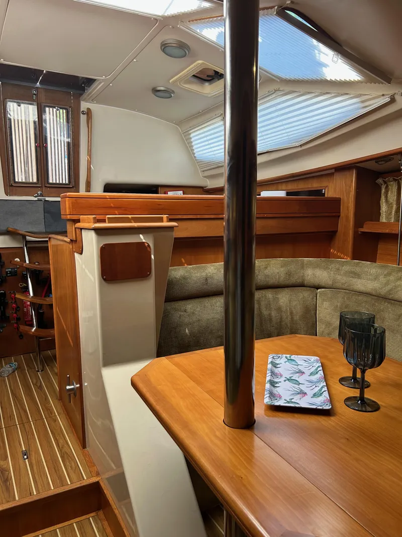 Slide: The Image of Interior of 2006 Southerly 115 Mk IV sailboat with wooden table and seating area. - 14