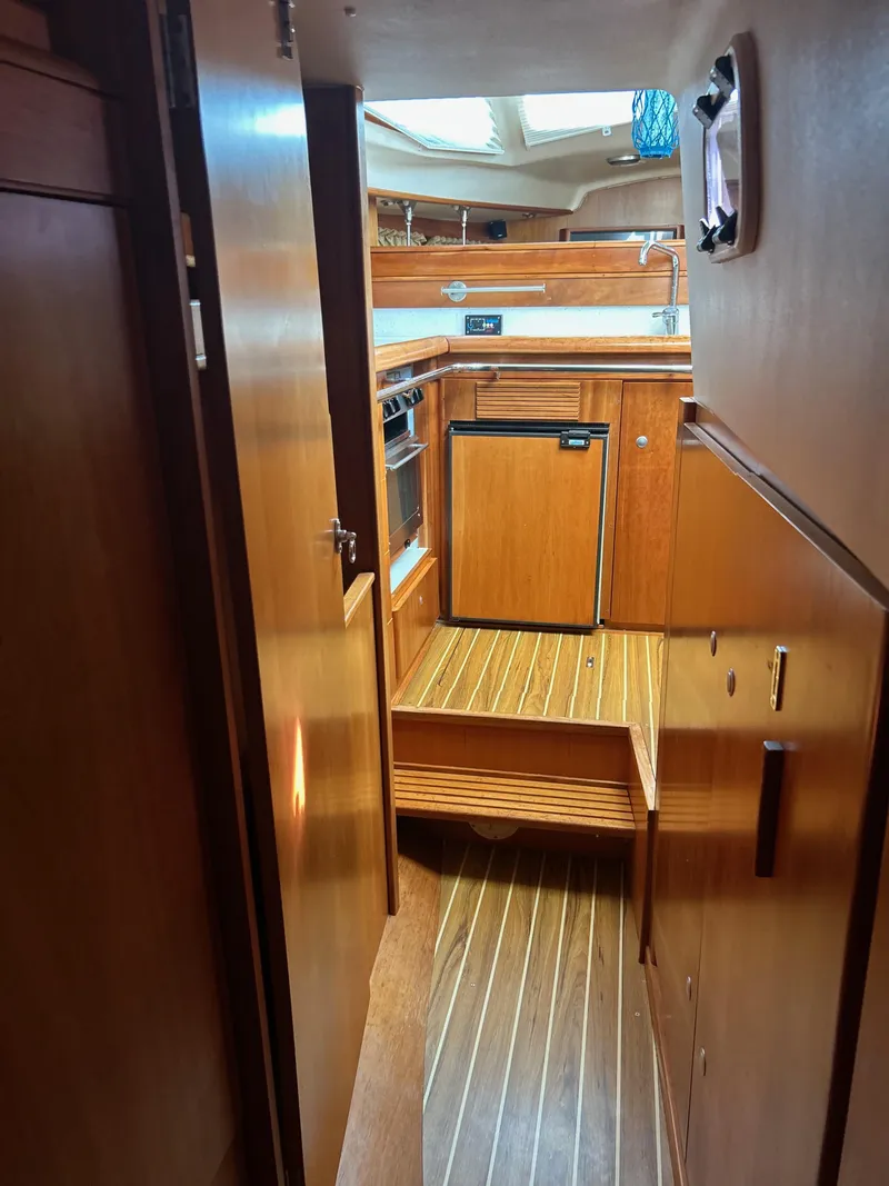 Slide: The Image of Interior of 2006 Southerly 115 Mk IV yacht with wooden cabinetry and compact kitchen. - 19
