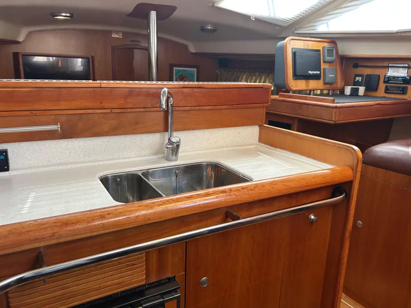 Slide: The Image of Interior of 2006 Southerly 115 Mk IV yacht with wooden cabinetry and stainless steel sink. - 24