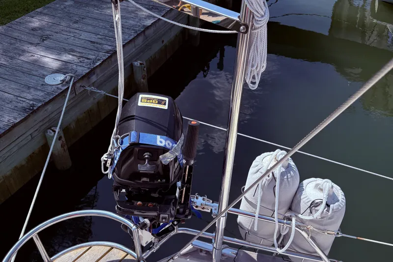 Slide: The Image of Outboard motor on a 2006 Southerly 115 Mk IV sailboat docked by wooden pier. - 33