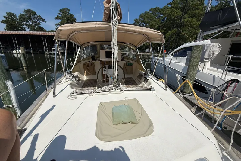 Slide: The Image of 2006 Southerly 115 Mk IV sailboat docked, featuring a spacious deck and covered cockpit. - 37