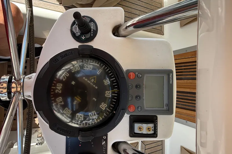 Slide: The Image of Steering console of 2006 Southerly 115 Mk IV sailboat with compass and navigation controls. - 44