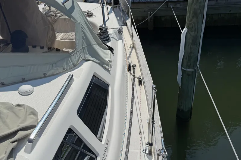 Slide: The Image of Deck view of a 2006 Southerly 115 Mk IV sailboat docked at a marina. - 55