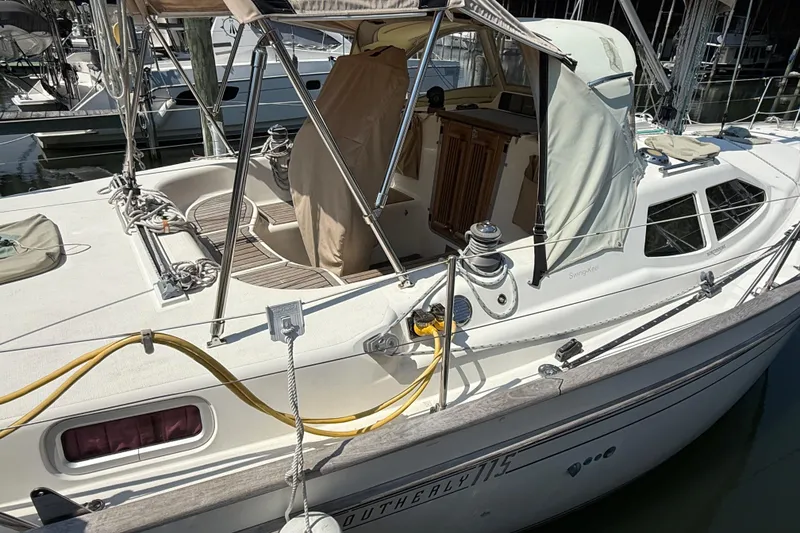 Slide: The Image of 2006 Southerly 115 Mk IV sailboat docked, featuring a covered cockpit and sleek design. - 63