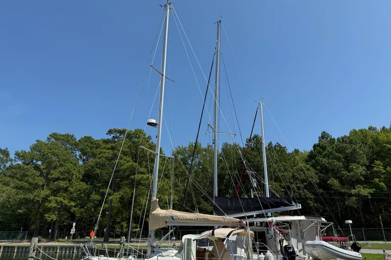 Slide: The Image of Sailboat Southerly 115 Mk IV (2006) docked, surrounded by trees under clear blue sky. - 68