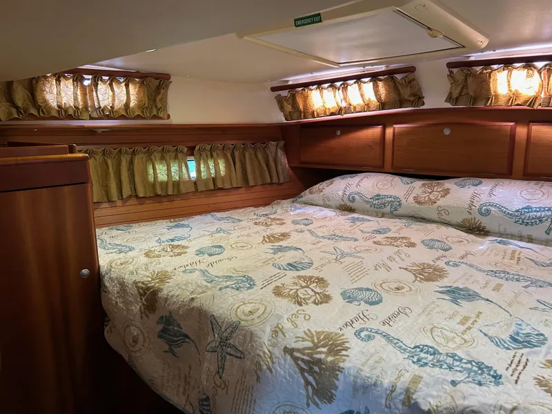 Slide: The Image of Cozy cabin interior of 2006 Southerly 115 Mk IV sailboat with nautical-themed bedding. - 7