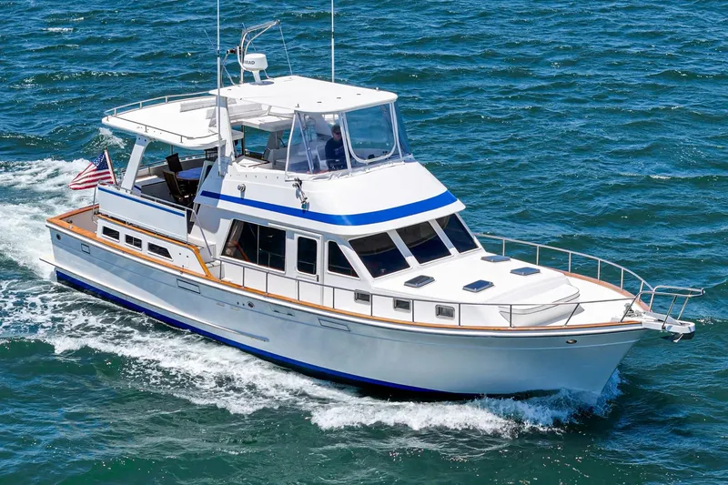 The Image of 1986 Offshore Yachts 48 Yachtfisher cruising on open water, showcasing sleek design and elegance. - 0