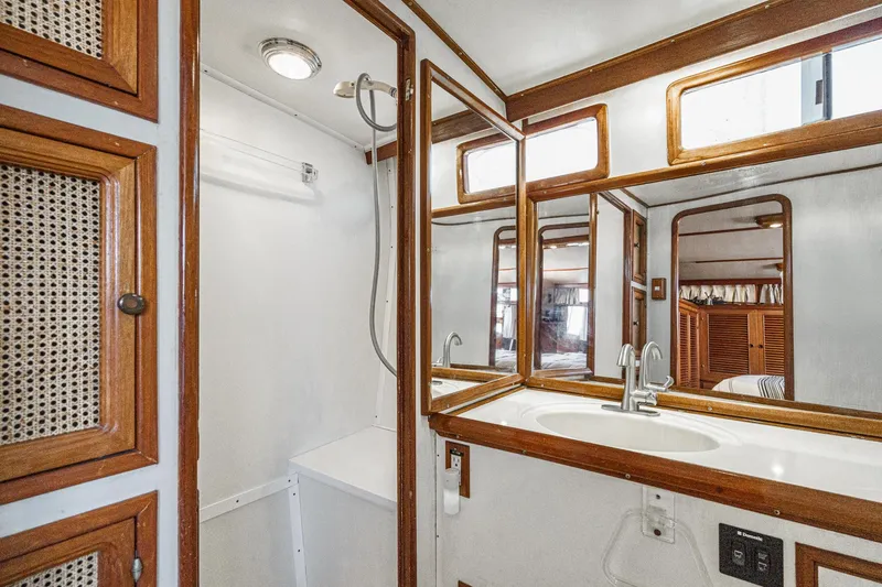 Slide: The Image of 1986 Offshore Yachts 48 Yachtfisher bathroom with wood accents and modern fixtures. - 25