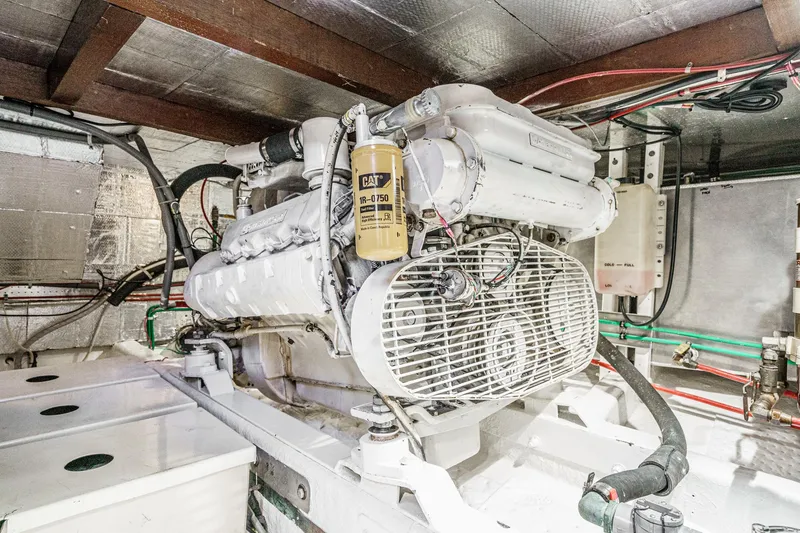 Slide: The Image of Engine room of 1986 Offshore Yachts 48 Yachtfisher, showcasing a well-maintained marine engine. - 30