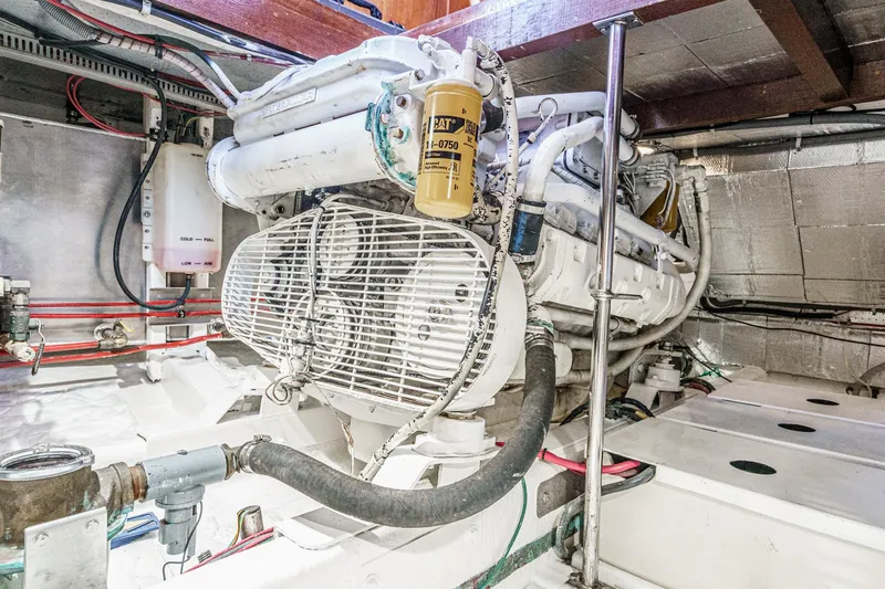 Slide: The Image of Engine room of 1986 Offshore Yachts 48 Yachtfisher, showcasing mechanical components and wiring. - 31