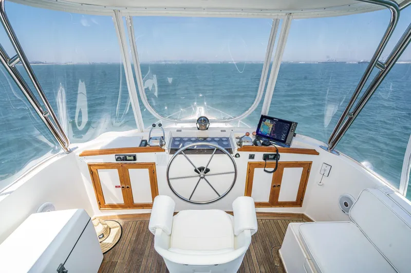 Slide: The Image of Helm of 1986 Offshore Yachts 48 Yachtfisher with ocean view and navigation equipment. - 5