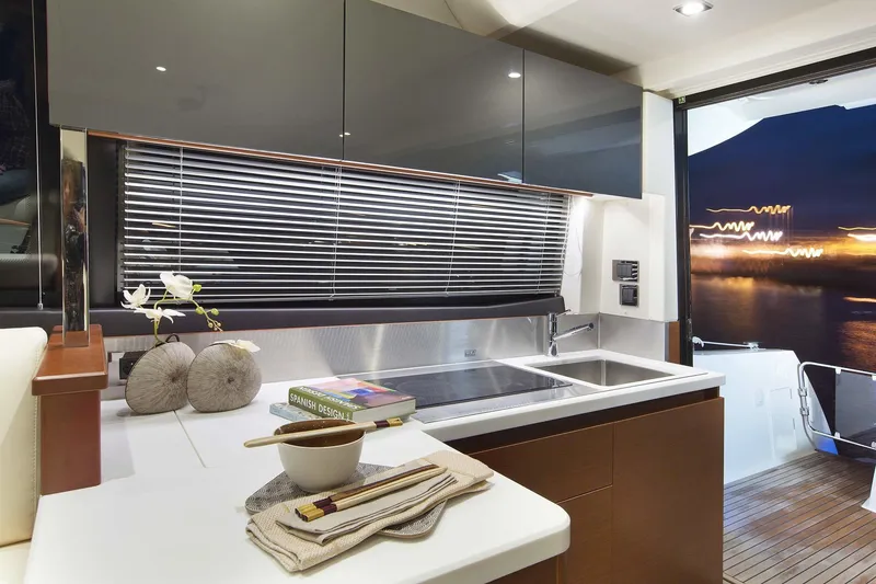 Slide: The Image of Luxurious interior of 2016 Prestige 450 S yacht with modern kitchen and night view. - 16