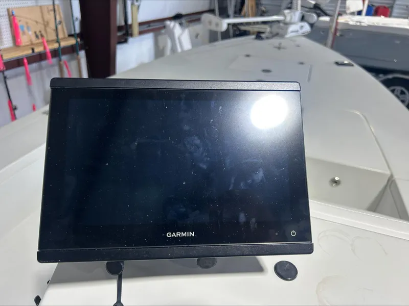 Slide: The Image of Garmin display on 2008 Lake & Bay Boca Grande boat dashboard in a garage setting. - 12