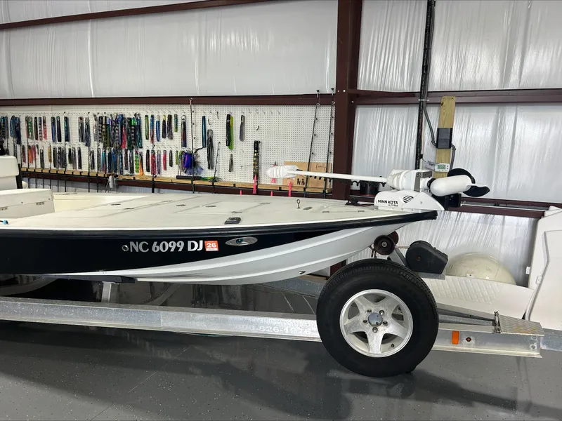Slide: The Image of 2008 Lake & Bay Boca Grande boat on trailer in storage with fishing gear. - 2