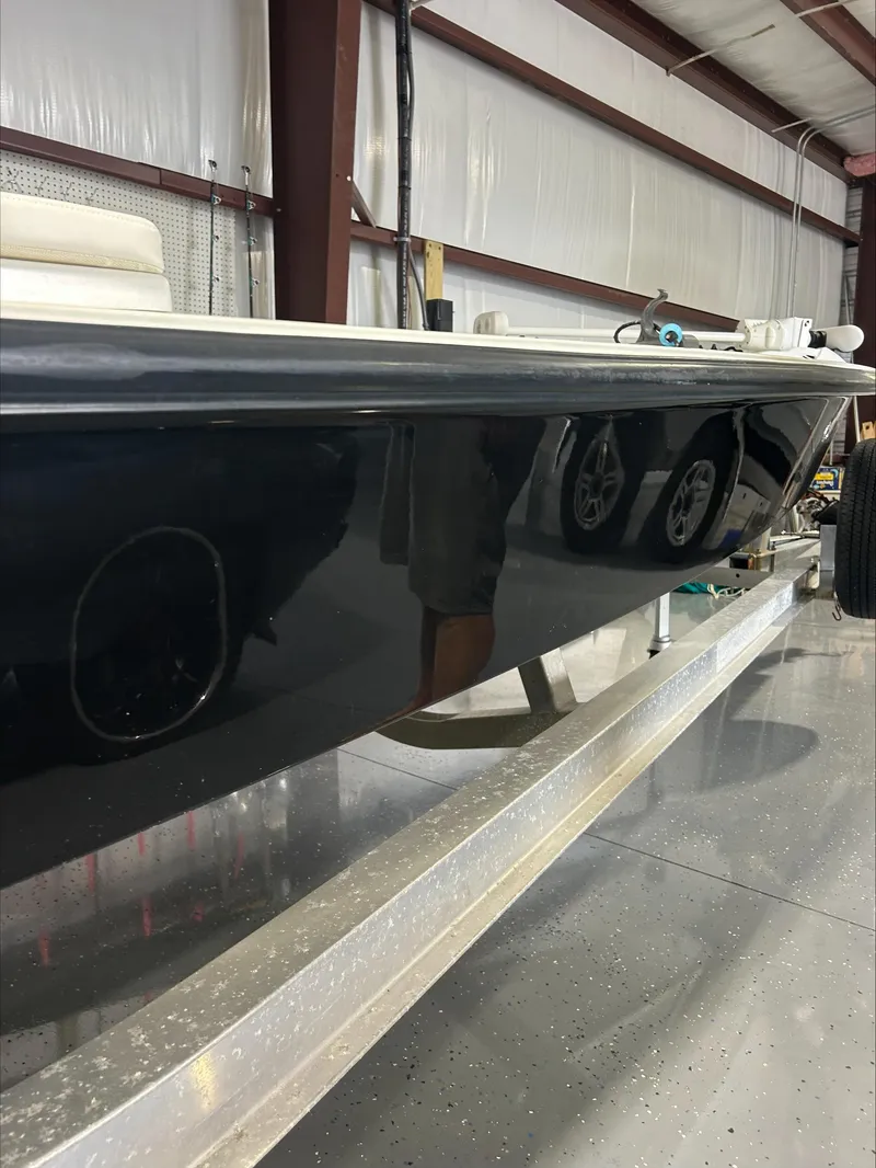 Slide: The Image of 2008 Lake & Bay Boca Grande boat in a garage, side view. - 25