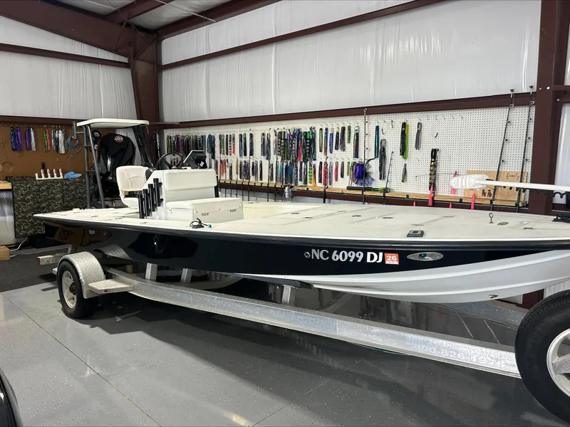 Slide: The Image of 2008 Lake & Bay Boca Grande boat on trailer in garage with fishing gear. - 4