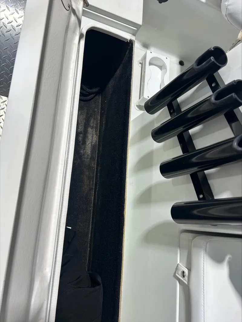 Slide: The Image of 2008 Lake & Bay Boca Grande boat interior with rod holders and storage compartment. - 9