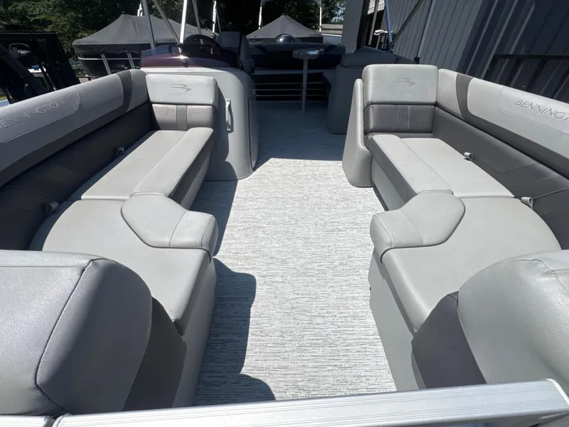 Slide: The Image of 2023 Bennington 22SX SWINGBACK pontoon boat interior with gray seating and spacious layout. - 12