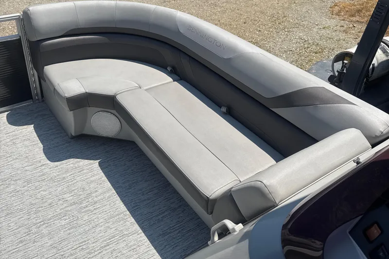 Slide: The Image of 2023 Bennington 22SX Swingback boat interior with gray cushioned seating. - 14