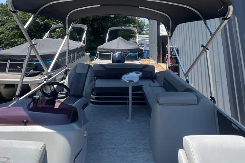 Slide: The Image of 2023 Bennington 22SX SWINGBACK pontoon boat interior with seating and canopy. - 16
