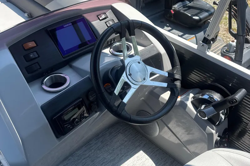 Slide: The Image of 2023 Bennington 22SX SWINGBACK boat helm with steering wheel and control panel. - 19