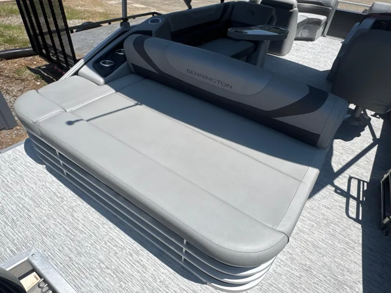 Slide: The Image of 2023 Bennington 22SX Swingback boat interior with gray seating and modern design. - 2