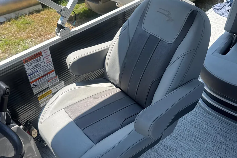 Slide: The Image of 2023 Bennington 22SX SWINGBACK boat seat with gray upholstery and armrests. - 20