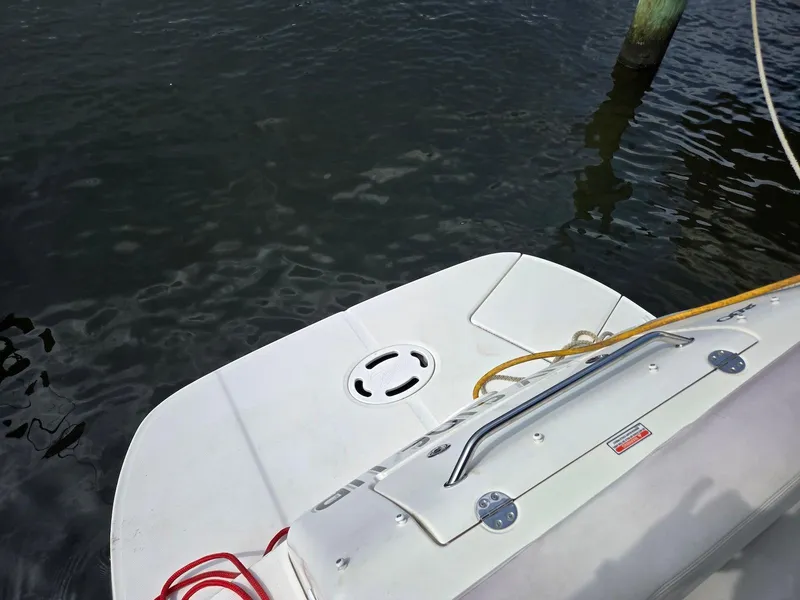 Slide: The Image of 2005 Sea Ray 280 Sundancer swim platform with ropes, docked on calm water. - 11