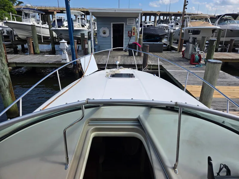 Slide: The Image of 2005 Sea Ray 280 Sundancer docked at marina, view from bow. - 12