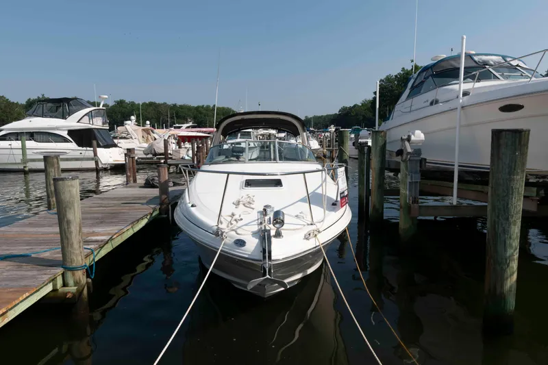 Slide: The Image of 2005 Sea Ray 280 Sundancer docked at marina, surrounded by other boats. - 2