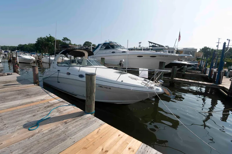 Slide: The Image of 2005 Sea Ray 280 Sundancer docked at marina, surrounded by other boats. - 3