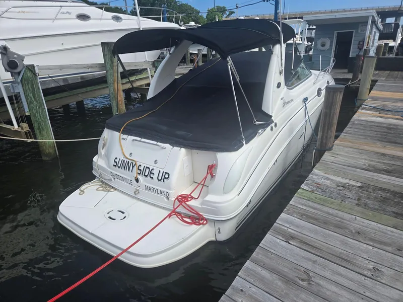 Slide: The Image of 2005 Sea Ray 280 Sundancer docked, covered, with "Sunny Side Up" name visible. - 4