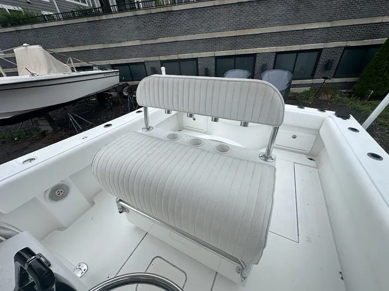 Slide: The Image of 2012 Onslow Bay 27 OE boat interior with white seating and cup holders. - 14
