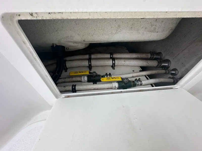 Slide: The Image of 2012 Onslow Bay 27 OE boat compartment with hoses and fittings. - 19