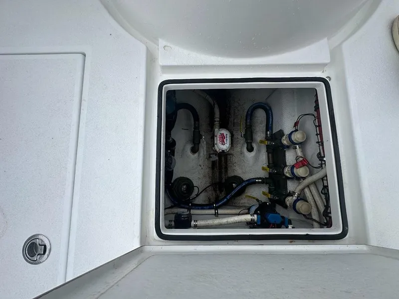 Slide: The Image of 2012 Onslow Bay 27 OE boat compartment with visible plumbing and wiring. - 20