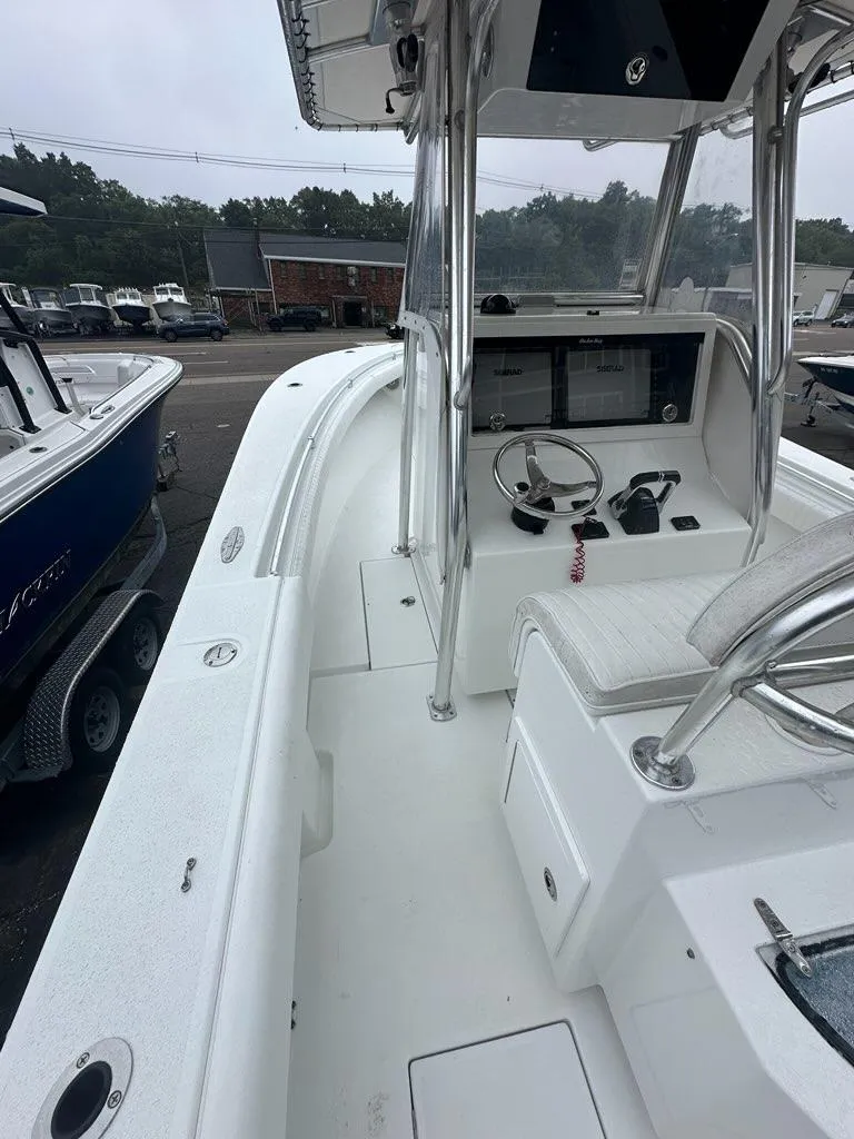 Slide: The Image of 2012 Onslow Bay 27 OE boat interior with steering console and seating. - 3