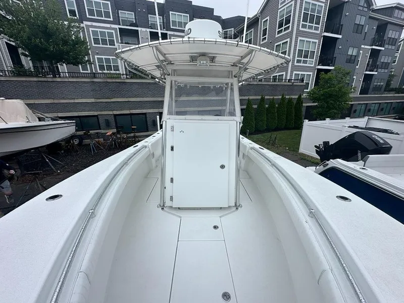 Slide: The Image of 2012 Onslow Bay 27 OE boat docked near modern apartments. - 8