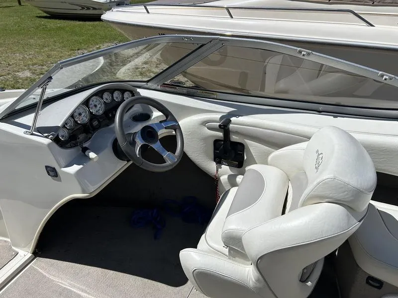 Slide: The Image of 2007 Stingray 210LR boat interior with steering wheel and white seating. - 10